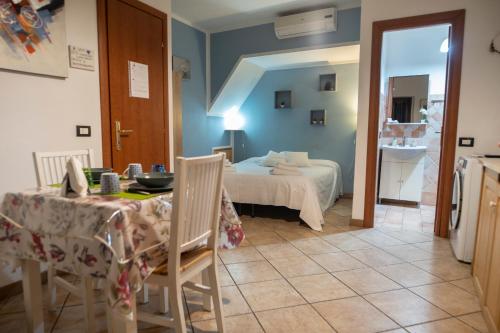 a room with a bed and a table in a room at Domoruja B&B in Sassari