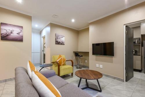 a living room with a couch and a tv at The Serenity Apartment 3 in Sandton