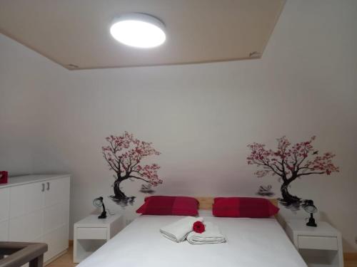 a bedroom with a bed with two trees on the wall at Il borgo nuovo, Pompei in Terzigno