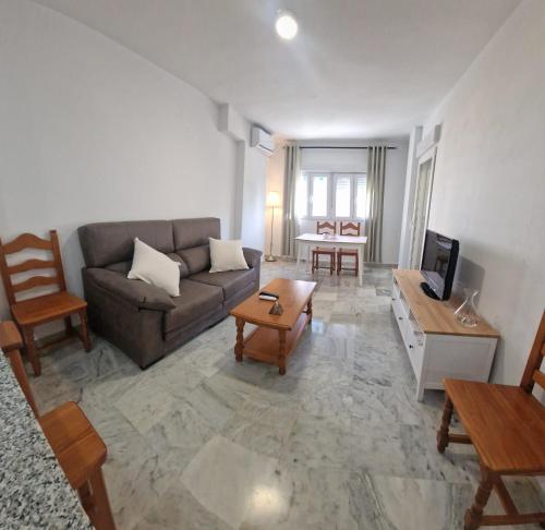 a living room with a couch and a table at Castillo Apartament in Torremolinos
