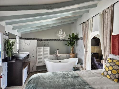 a bedroom with a bed and a tub and a sink at Casa Roberto Altea in Altea