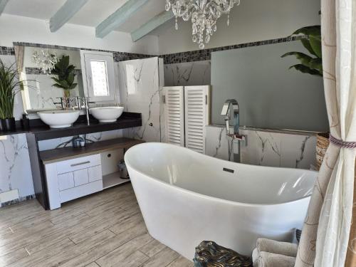 a bathroom with two sinks and a large tub at Casa Roberto Altea in Altea