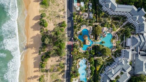 an overhead view of the pool and beach at Thavorn Palm Beach Resort Phuket in Karon Beach