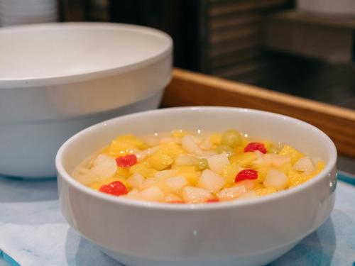 a white bowl of food on a table at Hearton Hotel Kita Umeda in Osaka