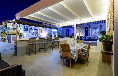 a restaurant with a table and chairs and a bar at Villa Barry Swimming Pool, Amazing Sea Views, Bar in Tarajalejo