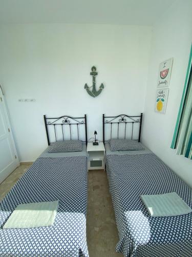 two beds sitting next to each other in a room at Villa Barry Swimming Pool, Amazing Sea Views, Bar in Tarajalejo
