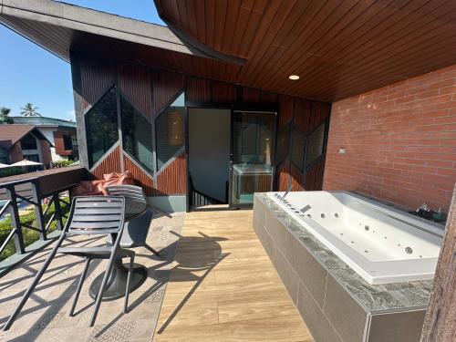 a house with a bath tub on a patio at โรงแรมชาวเกาะพีพี Chaokoh Phi Phi Island in Phi Phi Don
