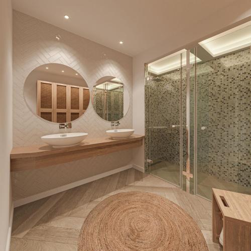 a bathroom with two sinks and two mirrors at Sirines Luxury Hotel & SPA- Adults Only in Rethymno Town