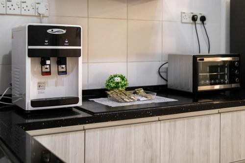 a coffee machine sitting on top of a kitchen counter at Comfy Sunset View Home with Swimming Pool & Netflix in Taiping