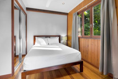 a bedroom with a bed and a window at Pole home in paradise at Kuranda in Kuranda