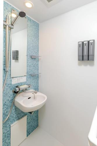 a bathroom with a sink and a mirror at en stay 005 in Osaka