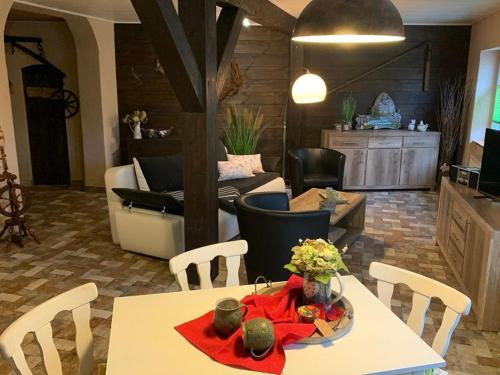 a living room with a table and chairs at Inas Spreewaldstube in Vetschau