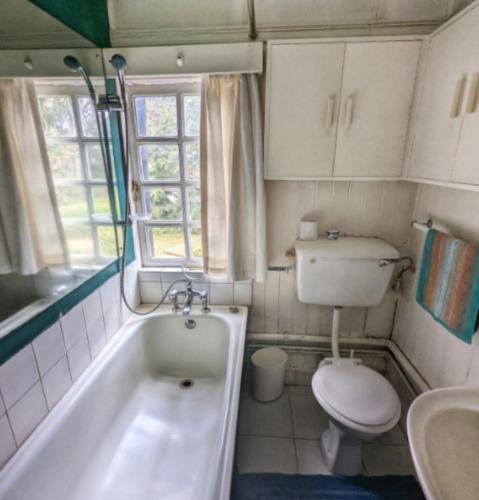 a bathroom with a tub and a toilet and a sink at Baraka in Nairobi