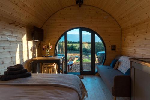 a room with a bed and a room with an open door at Stargaze at OLJU Lodges in Stithians