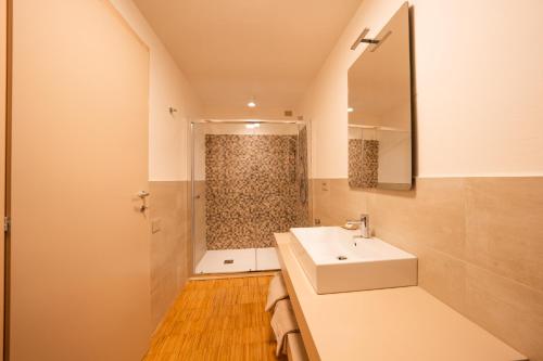 a bathroom with a white sink and a shower at Elena - CASA VACANZE BALDASSINI N 15 in Gubbio