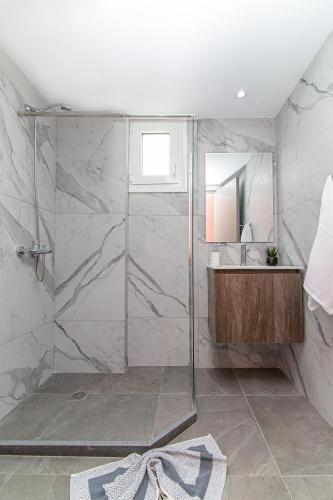 a bathroom with a shower and a sink at Theoni Apartments in Malia
