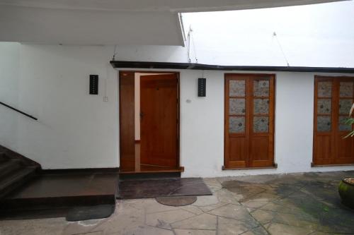 an empty room with two doors and a staircase at Embassy Suites in Colombo