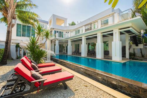 an exterior view of a house with a swimming pool at Villas In Pattaya in Jomtien Beach