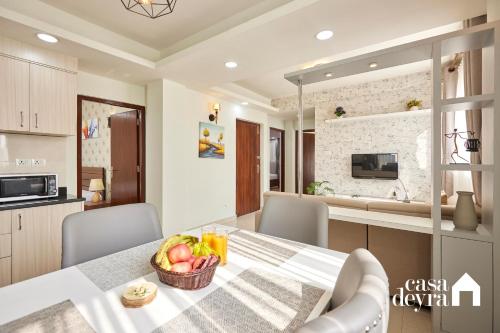 a kitchen and dining room with a table with a bowl of fruit at Jhamel Apartments 2 by Casa Deyra in Pātan