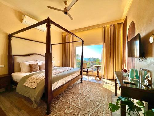 a bedroom with a canopy bed and a large window at IRAH by Parvatah in Bīr