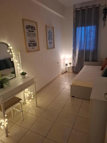 a bedroom with a bed and a table and a mirror at 9 keys boutique apartments in Orestiada