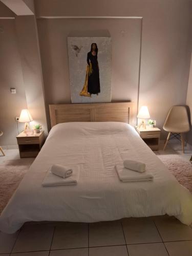 a bedroom with a large white bed with two towels at 9 keys boutique apartments in Orestiada
