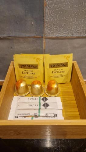 a wooden tray with two boxes and two bells at Les Carmélites in Rouen