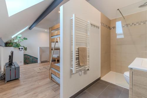 a bathroom with a staircase and a toilet in a room at Disney Cosy Cottage, 5 minutes Disneyland! in Magny-le-Hongre