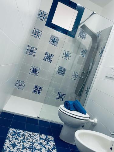 a blue and white bathroom with a toilet and a sink at Agape in Policoro