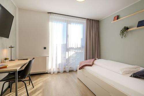 Ένα ή περισσότερα κρεβάτια σε δωμάτιο στο The Base Berlin ONE