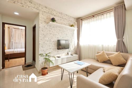 a living room with a couch and a tv at Jhamel Apartments 2 by Casa Deyra in Pātan
