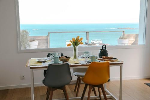 - une table à manger avec vue sur l'océan dans l'établissement Terrasse face à l'océan pour 4 personnes, à Plouguerneau