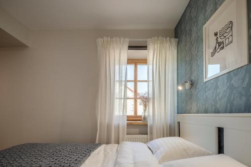 a bedroom with a bed and a window at B2 Apartments in Klaipėda