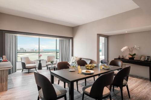 a living room with a table and chairs at Ascott Gurney Penang in George Town