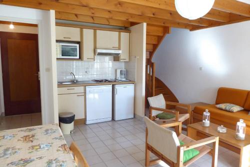 une cuisine et un salon avec une table et des chaises dans l'établissement REF 080 Maison pour quatre personnes avec garage Arzon, à Arzon