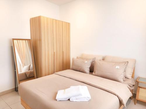 a bedroom with a bed with two towels on it at Flora Residency KL -- Botanical Vibes #3BR2B #1-7 pax by Cowidea in Kuala Lumpur