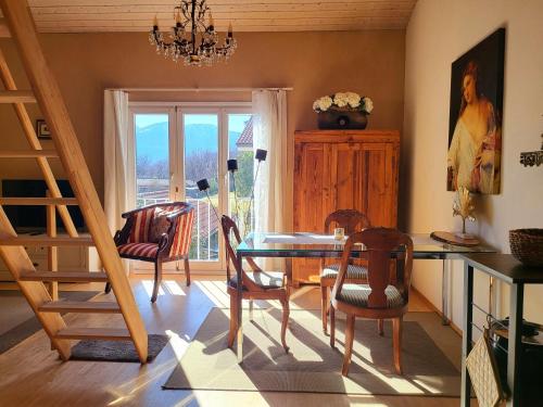 a dining room with a glass table and chairs at Traum Ferienwohnung am Strand im Tessin - nur 3km von Ascona oder Locarno entfernt in Tegna