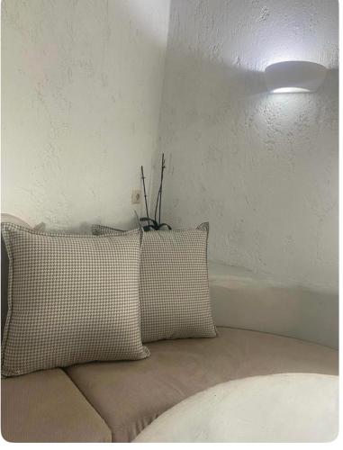 a couch with two pillows in a room at Sakas Residences in Karterados