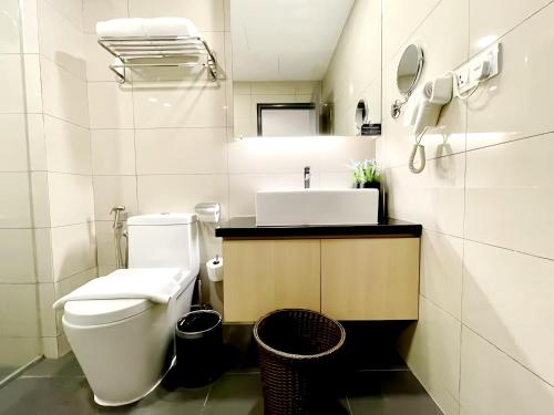 a bathroom with a white toilet and a sink at Grand Ion Genting Highlands in Genting Highlands