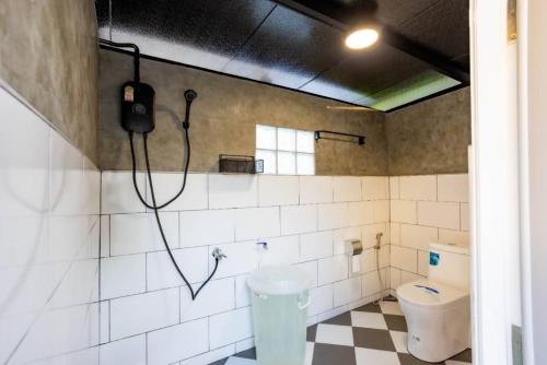 a bathroom with a toilet and a phone on the wall at Wanna house บุรีรัมย์ ใกล้สนามช้างอารีน่า in Buriram