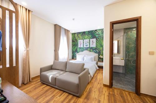 a hotel room with a bed and a couch at Sarah Hotel Halal Restaurant Phu Quoc in Phu Quoc
