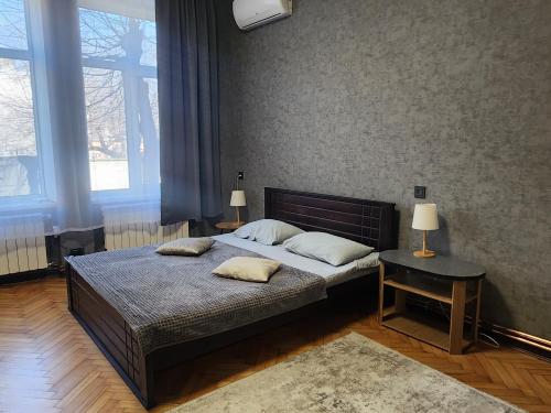 a bedroom with a bed with two pillows on it at O.O.APART.2 in Chernivtsi