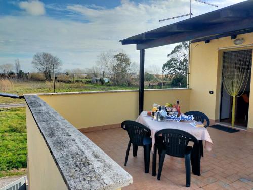 a table and chairs sitting on a patio at RicHouse by Holiday World in Fiumicino