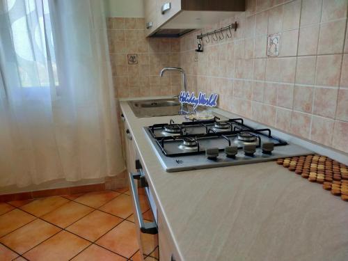a kitchen with a stove and a counter top at RicHouse by Holiday World in Fiumicino