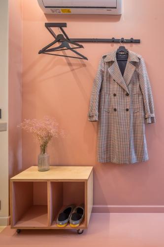 a coat hanging on a wall next to a table at B2 Apartments in Klaipėda