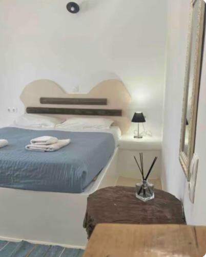 a bedroom with a bed and a table and a mirror at Sakas Residences in Karterados