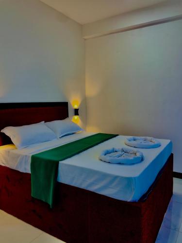 a bedroom with a bed with two towels on it at Cozy forest ella in Ella