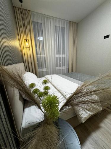 a bedroom with a bed with plants in it at Апартаменти в новобудові Авалон Зелена in Lviv