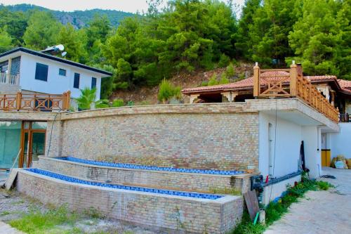 a brick wall next to a house with a balcony at The Vista Village in Kumluca