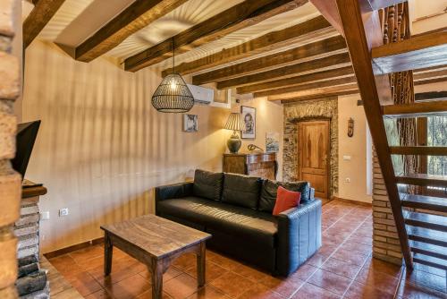 a living room with a couch and a table at Cal Matalí in Espolla